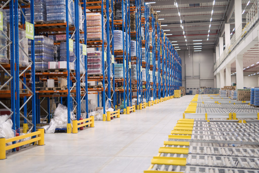 Warehouse storage interior with shelves loaded with goods.